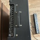 Černý kytarový kombozesilovač s ovládacím panelem a přenosnou rukojetí. Na předním panelu jsou viditelné nápisy BOSS, AMPLIFIER (GAIN, VOLUME), EQUAL…