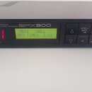 Černý efektový procesor s nápisy YAMAHA PROFESSIONAL MULTI-EFFECT PROCESSOR a SPX900. Zařízení má podsvícený zelený displej s textem REVB HALL a REV…