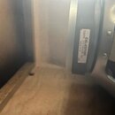 Detailní pohled na zadní část reproduktoru s kovovým rámem. Na černém magnetu je bílá nálepka s nápisy T3897B, CELESTION, G12 VINTAGE 16Ω a MADE IN U…
