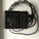 Černý síťový adaptér s přiloženým kabelem. Na povrchu je bílý nápis YAMAHA a text EXTERNAL AC POWER ADAPTOR, MODEL: PA-3B, INPUT: AC100-240V 50Hz, OU…