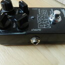 Černý kytarový efekt s nápisy DARK MATTER DISTORTION, tc electronic a true bypass. Na horní straně jsou čtyři černé ovládací knoflíky s popisky GAIN,…