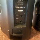 Zadní panel černého reproduktorového boxu s nápisem ZX4. Je zde logo a název Electro-Voice, štítek s číslem 05090M0071 a text PATENT PENDING. Panel o…