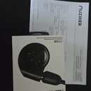 Fotografie zobrazuje krabičku od sluchátek s nápisy „audio-technica“ a „ATH-E40“. Vedle krabičky je položen fakturační doklad od společnosti „MUZIKER…