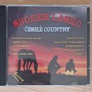 Plastové CD pouzdro s papírovým obalem. Na obalu je červený nápis SBOHEM LÁSKO a pod ním bílý text ČESKÉ COUNTRY. V dolní části jsou seznamy skladek…