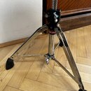 Fotografie zachycuje spodní část chromovaného stativu s černými gumovými paticemi. Na černém plastovém spoju je viditelný červenobílý nápis „oralton“…