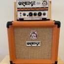 Kytarový kombozesilovač tvořený hlavou a samostatným boxem v oranžovém provedení. Na hlavě je nápis ORANGE, MICRO TERROR 20W RMS a logo s postavou. P…