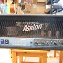 Černý basový kombozesilovač s kovovou mřížkou, na které je bílé logo Ashton. Na spodním ovládacím panelu jsou nápisy Ashton, BV300 a ALL TUBE BASS AM…