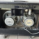 Zadní strana černého kytarového komba s otevřeným zadním panelem. V interiéru jsou dva reproduktory s bílými popisky, na kterých je uvedeno G12-80 a…