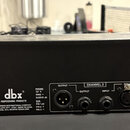 Zadní strana černého rackového zařízení s logem dbx PROFESSIONAL PRODUCTS. Na štítku je uveden nápis A HARMAN INTERNATIONAL COMPANY SALT LAKE CITY, U…