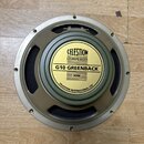 Kruhový reproduktor s kovovým rámem v béžovém odstínu a černou membránou. Uprostřed je žlutý štít s nápisy CELESTION LOUDSPEAKERS, G10 GREENBACK a 30…