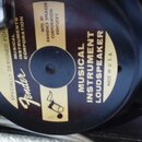 Fotografie zachycuje reproduktor s černým membránovým povrchem a béžovými štítky. Na středovém štítku je bílé logo Fender a nápisy SPECIALLY DESIGNED…
