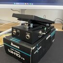 Černý wah pedál s nápisem WH10v3 na boku. Na zadní straně jsou konektory s popisky INPUT, DC9V a OUTPUT a přepínač s nápisy TRUE BYPASS a BUFF. Pedál…