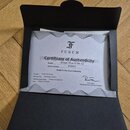 Černá krabička s dokumenty, z nichž je vidět certifikát pravosti. Na papíře je logo F s nápisem FURCH a text Certificate of Authenticity. Jsou zde uv…