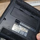 Záběr na spodní stranu černého efektového pedálu z plastu. Na zařízení je vidět logo ZOOM a nápis „eco : Activate the power management function.“. St…