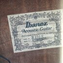 Fotografie detailu štítku uvnitř akustické kytary. Na štítku je uveden nápis Ibanez Acoustic Guitar, text Hand crafted from select woods in Japan a M…