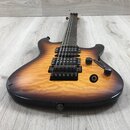 Elektrická kytara s prohnutým topem z plameníného dřeva v žlutě-černém sunburst provedení. Nástroj má tři černé humbuckery, dva ovládací knofíky a je…