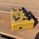 Žlutý efekt pedál s kovovým tělem a černými ovládacími knoflíky. Na horní straně je uveden nápis MXR a text MMX INNOVATIONS, na boku je nápis sub oct…