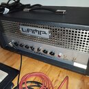 Kytarový kombozesilovač v černém krytu s kovovou mřížkou a ovládacím panelem z broušeného kovu. Na mřížce je nápis L-AMP a na ovládacím panelu text G…