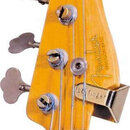 Detail hlavy basové kytary z přírodního dřeva s viditnou masivní strukturou. Na povrchu je nápis "PRECISION BASS" a nečitelně psaný podpis. Nástroj m…