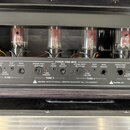 Záběr na zadní panel kytarového zesilovače s nápisem POWER TUBE BIAS. Jsou vidět čtyři elektronky, u kterých jsou označení TUBE 1 až TUBE 4. Panel ob…