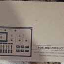 Kartonová krabice s obrázkem a popisem digitálního záznamového zařízení. Na krabici je uveden název ZOOM R12 MultiTrak a označení PORTABLE PRODUCTION…