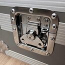 Detailní záběr na kovový zapínací zámek šedého transportního kufru s hliníkovými lištami. Zámek je vyroben z anodizovaného kovu a připevněn k povrchu…