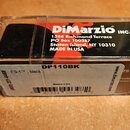 Průhledný plastový obal s černým produktem uvnitř. Na horní části je bílý nápis DiMarzio INC. a adresa 1388 Richmond Terrace PO Box 100387 Staten Isl…