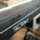 Záhlaví černé klaviatury s ventilací a konektory. Na štítku je viditelné logo YAMAHA a nápisy: YAMAHA STAGE PASSPORT KEYBOARD, MODEL / CPE NAME, YAMA…