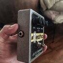 Kompaktní efekt pedál v šedém kovovém provedení. Na čelní straně je nápis #1 echo a logo electro-harmonix s doplňkem MADE IN NYC, USA. Pedál má dva č…