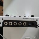 Zadávací panel bílého elektronického zařízení s nápisem CDCM HD + F.I.R.E. Panel obsahuje pět vstupních/výstupních konektorů typu jack a jeden vypína…