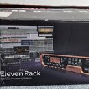 Fotografie znázorňuje originální kartónovou krabici s produktem. Na černé ploše je bílý nápis „Pro Tools + Eleven Rack“ a pod ním text „Revolutionary…
