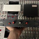 Černý rackový přístroj s nápisem STEREO LIMITER a logem D&B. Na předním panelu jsou dva červené otočné ovladače s popisky threshold a output, jeden b…
