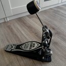 Černý pedál basového pedálu s kovovými prvky. Na šlapce je bílý nápis IRON COBRA The Legend In Innovation 500 a na patě značka TAMA. Povrch vykazuje…