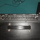 Černý kytarový kombozesilovač s ovládacím panelem. Na levé straně je logo v podobě meče a nápis KATANA-100 MKII. Ovládací panel obsahuje sekce AMPLIF…
