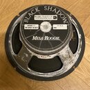Kruhový reproduktor s černým membránovým kónem a šedým rámem. Na horním krytu je nápis BLACK SHADOW, logo CELESTION INTERNATIONAL a značka Mesa/Boogi…