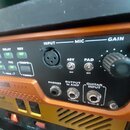 Detailní pohled na přední panel rackového procesoru v oranžovém šasi s černým ovládacím panelem. Jsou zde viditelné nápisy Eleven RACK, INPUT MIC GAI…