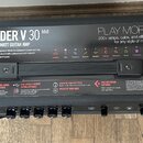 Černý kytarový kombo zesilovač s nápisem SPIDER V 30 MkII a označením 30-WATT GUITAR AMP. Na přední straně jsou čtyři ovládací knoflíky, několik tlač…