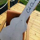 Šedý tvrdý pouzdro na kytaru s texturovaným povrchem. Na hrazdě je černý nápis „Cole Clark“. Povrch pouzdra vykazuje několik tmavších šmouh a znečišt…