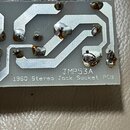 Detailní pohled na tiský spoj (PCB) s viditelnými vodivými cestami a pájecími body. Na spodní části desky je bílý nápis JMP53A a pod ním text 1960 St…