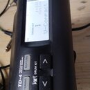 Černý elektronický perkusní modul Roland TD-4 Percussion Sound Module. Na displeji je vidět text V-Compact, J=126 a Xstick. Zařízení vykazuje mírné o…