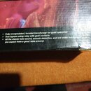 Fotografie zachycuje detail boku kartonové krabice s textem v angličtině. Je na ní uveden seznam vlastností: „Fully encapsulated, toroidal transforme…