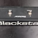 Černý obdélníkový pedál s čtyřmi stoupacími spínači. Na přední straně je bílý nápis Blackstar®. Nad spínači jsou zleva doprava nápisy OD, CRUNCH a CL…
