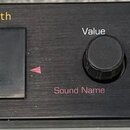 Černý rackový syntetizátor s nápisem ENSONIQ a označením 64 Voice Expandable Synth. Na předním panelu je LCD displej, pod ním nápis SoundFinder™, ová…