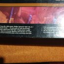 Fotografie detailu zadní strany obalu produktu s anglickým textem. Text obsahuje zmínky o komponentech jako „Phillips Sylvania® 6021 MIL-E-1 spec sub…