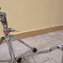 Dvě chromované stojany na bicí nástroje. Na obou je viditelný červený štítek s bílým nápisem Garland. Povrch chromu vykazuje známky opotřebení a oxid…
