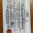 Bílá plastová karta s nápisem Certificate of Authenticity a logem BRITISH PEDAL CO. LONDON ENGLAND. U políčka MODEL je ručně napsáno PEPNOX. Karta ob…