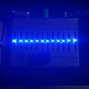 Stříbrný grafický ekvalizér s nápisy MXR a ten band eq. Zařízení má deset posuvníků pro různé frekvence od 31,25 do 16K a dva ovládací prvky označené…