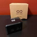 Černý kompaktní MIDI převodník s nápisy GO, MIDI HOST a behringer na horní straně. Na přední straně jsou dva USB porty s popisky USB HOST a POWER a m…