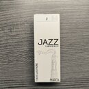Bílá krabička s trosečatými trsy saxofonu. Na přední straně je černý nápis JAZZ a pod ním text 5 UNFILED REEDS, v dolní části je uvedeno MARCA a svis…