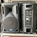 Dva černý plastové aktivní reproduktory. Na levém je v dolní části modrý štítek s nápisem OPERA LIVE 210 a logem db technologies. Pravý reproduktor j…